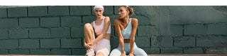 Sporty woman in stylish womens gym wear holds a tennis racket, ready for a match in her fashionable dress.